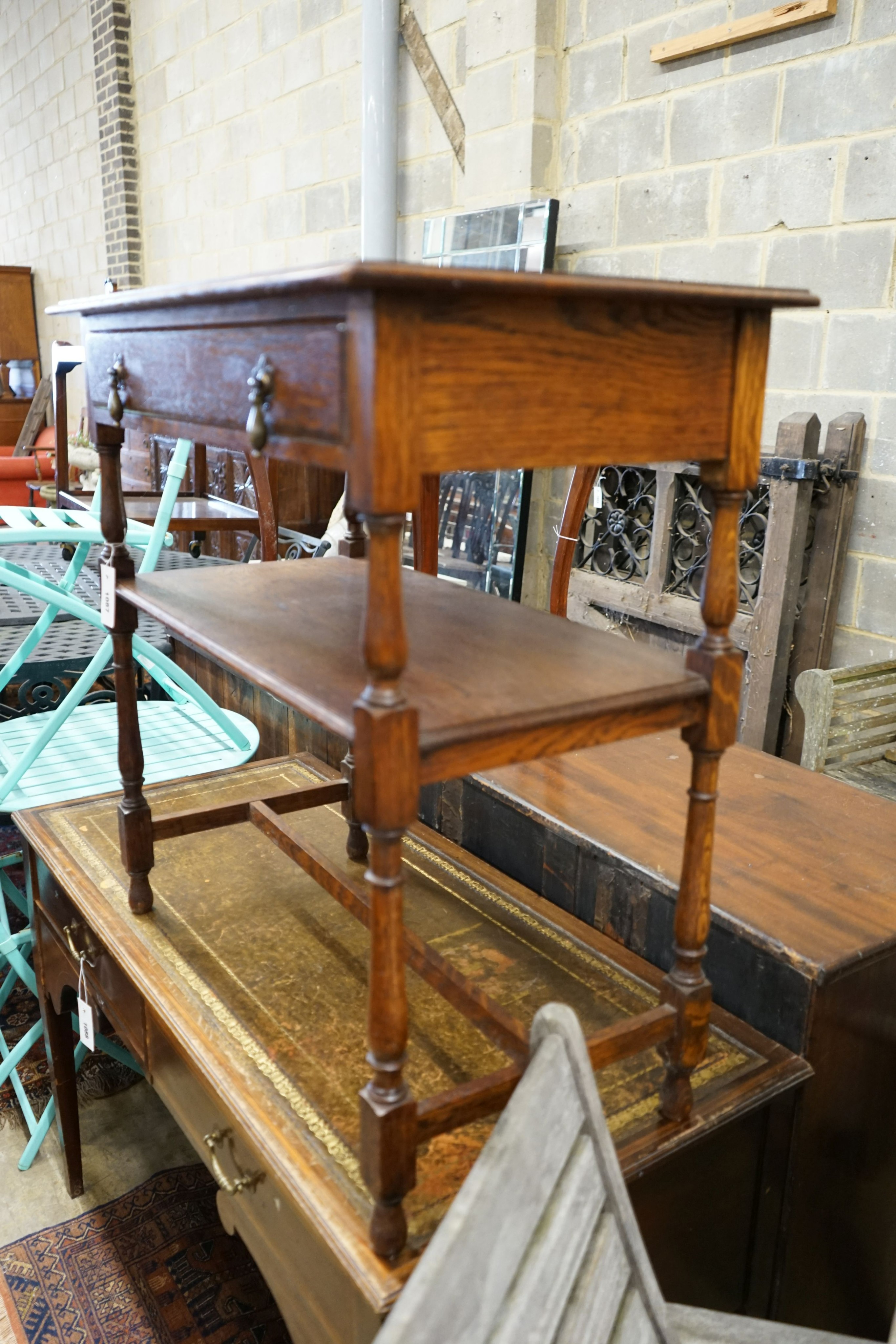 A Liberty style hexagonal oak two tier table, width 47cm, height 71cm together with a rectangular oak two tier table